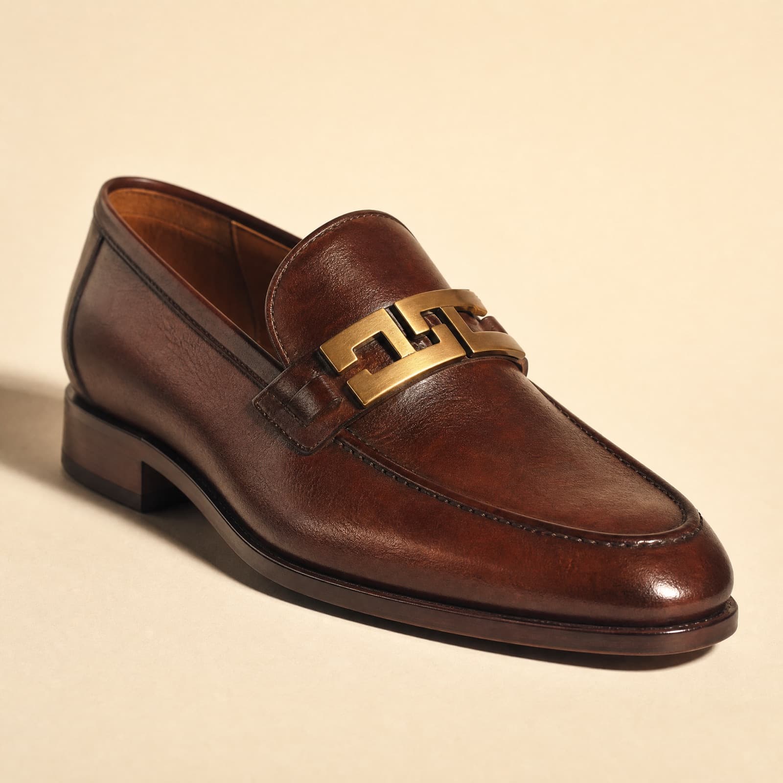 Bar Loafer — An original interlocking bar in aged brass.